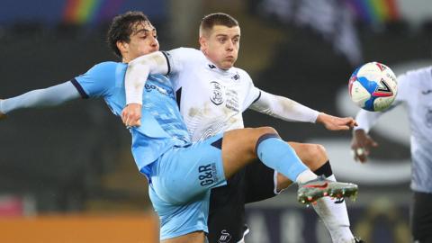 Jake Bidwell of Swansea City battles for possession with is Tyler Walker of Coventry City