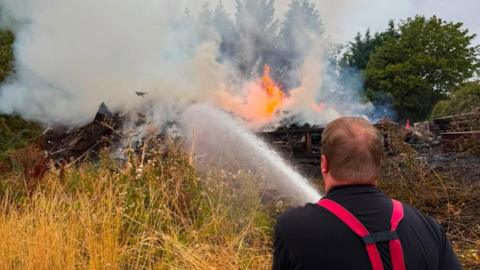 Firefighters in Nottinghamshire dealing with a bonfire near Kirkby-in-Ashfield