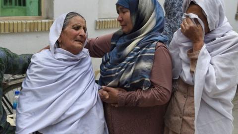 Afghan women weep for their relatives at the Isteqlal Hospital after a suicide attack in Kabul, 11 June 2018