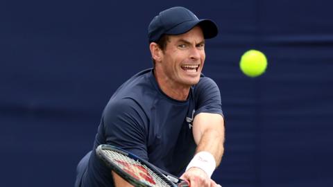 Andy Murray hits a return during practice at Queen's