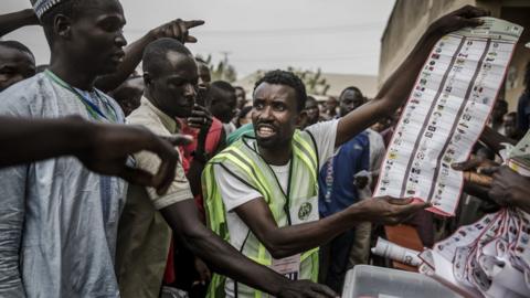 Discussion between voters and electoral officers at a polling station in Yola, Adamawa state, 23 February