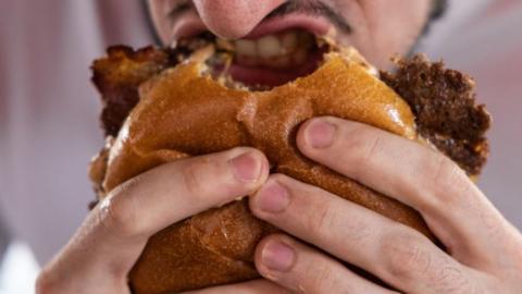 Man eating burger