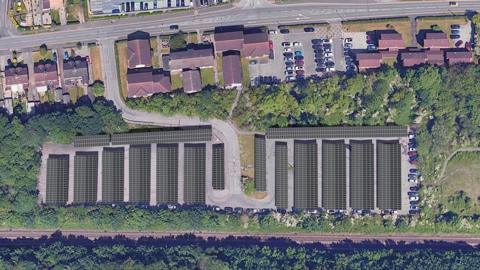 An aerial artist's impression of the new solar carports showing rows of panels surrounded by a railway line and trees 