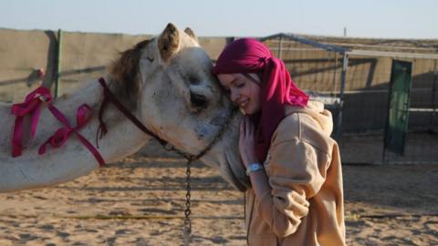 Katie hugging a camel