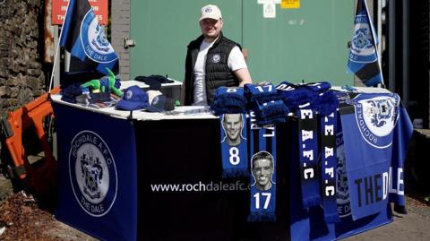 A scarf seller outside Rochdale's Spotland Stadium