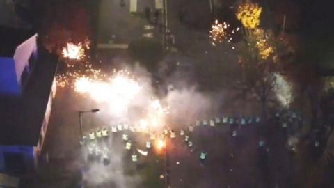 Fireworks being thrown at a line of police in the Niddrie area of Edinburgh