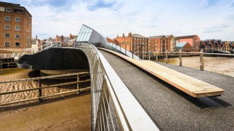 Scale Lane Bridge. The muddy banks of the river can be seen beneath it. 