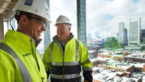 Two men on building site