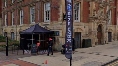 The canopy and sign of the bike park outside Leicester Town Hall
