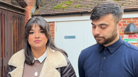 a man and a woman standing outside