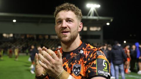 Dragons co-captain Angus O'Brien applauds the fans at Rodney Parade