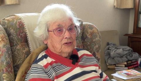 Elderly woman sitting on chair