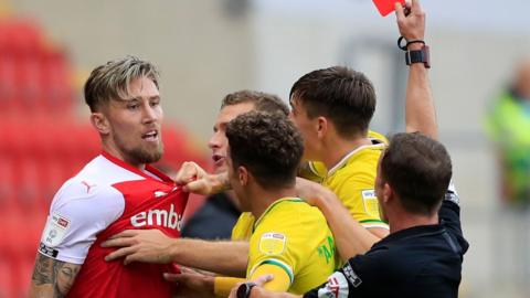 Rotherham defender Angus MacDonald (left) is sent off for a foul on Norwich midfielder Oliver Skipp