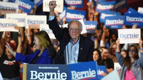 Bernie Sanders lifts his fist at a campaign rally in San Antonio, Texas