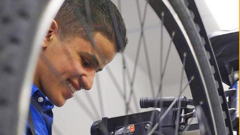 Boy fixing a bike