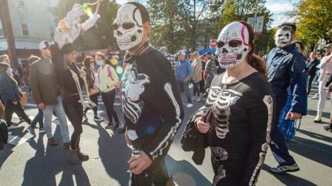 Two people dressed in skeleton costumes