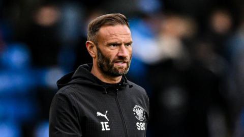 Blackpool boss Ian Evatt looks on
