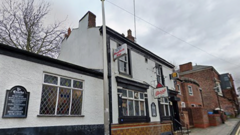 Ye Cracke pub in Rice Street in Liverpool. It is a mid-19th century pub with whitewashed walls and black window edgings.