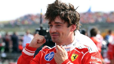 Ferrari's Charles Leclerc smiles and pumps his fist in celebration after winning the British Grand Prix