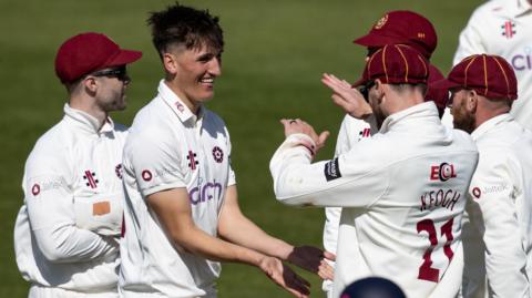 Raphy Weatherall celebrates taking a wicket for Northamptonshire with team-mates