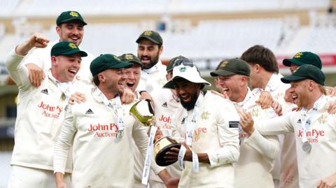 Nottinghamshire players lift the County Championship trophy