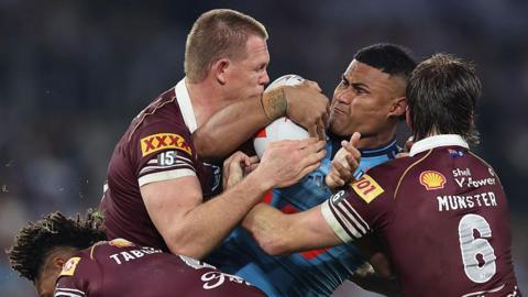 Haumole Olakau'atu of New South Wales is tackled during the game