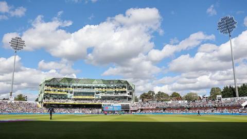 Headingley Cricket Ground with the pavilion in the centre and floodlights either side.
