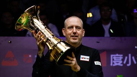 Mark Williams celebrates with the trophy