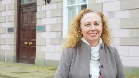 Deputy Inna Gardiner speaking in Jersey's Royal Square, outside the States Chamber