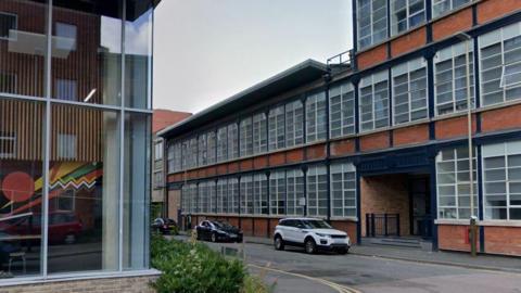 A two-storey building next to a four-storey building in Henshaw Street