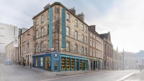 The building on the corner of Bristo Place and Bristo Port is a stone-built property with four floors. The ground floor has a blue frontage and there are signs and logs of the Society of Antiquaries of Scotland.
