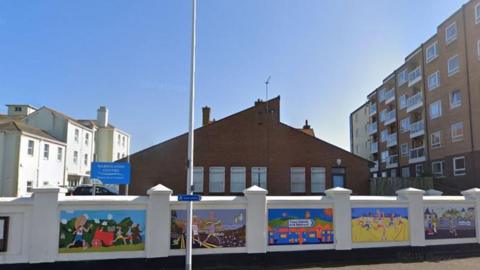 The Marshlands Centre in Seaton with a wall in front featuring colourful murals.