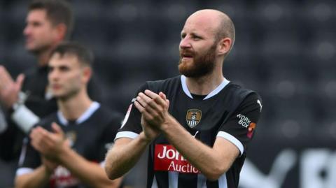 Curtis Edwards claps the crowd after a win for Notts County