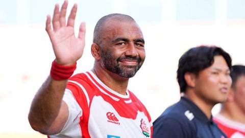 Japan captain Michael Leitch waves towards the camera