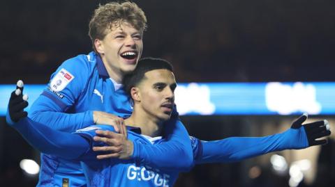 Peterborough United midfielder Brandon Khela (8) celebrates with Peterborough United forward Gustav Lindgren (19)