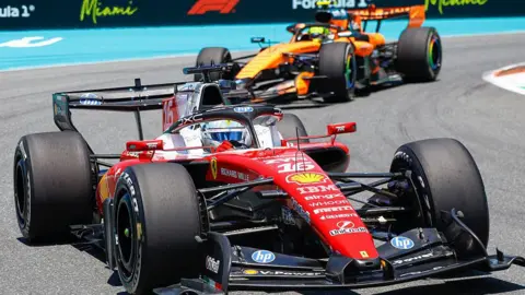 A close-up image of Ferrari's Charles Leclerc with McLaren's Lando Norris behind him during practice for the Miami Grand Prix