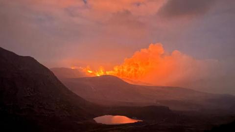 A large fire over the Mourne Mountains at twilight 