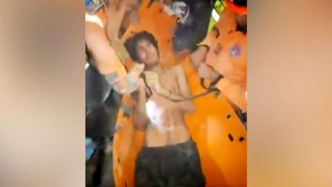 A 21-year-old man being pulled from rubble in Venezuela's La Guaira state
