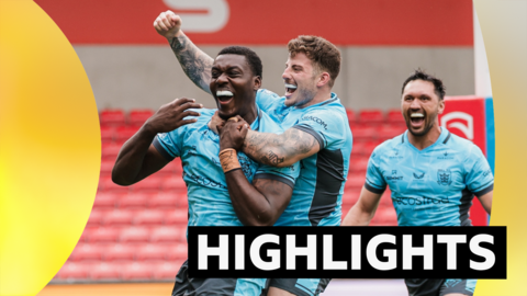 Sam Eseh of Hull FC celebrates with Amir Bourouh and Jordan Rapana after scoring a try.