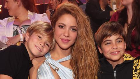 Shakira is pictured with her two sons, young boys around the age of 10