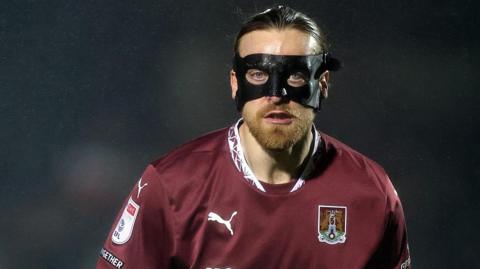 Northampton Town forward Tom Eaves wearing a mask during the game with Cambridge United because of facial injuries