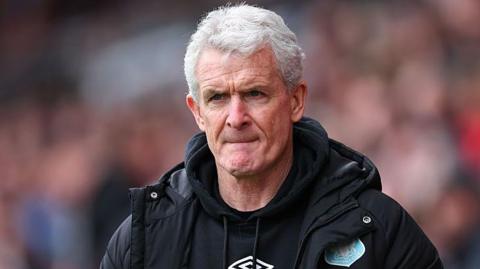 Manager Mark Hughes watches his Carlisle United team play against Doncaster Rovers in March 2025