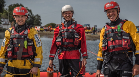 Three SARA crew members dressed in life-saving uniform