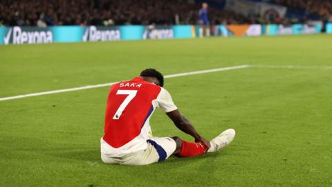 Bukayo Saka of Arsenal reacts after picking up an injury
