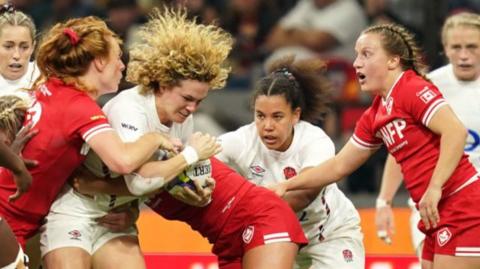 England and Canada players compete for the ball in a 2024 match