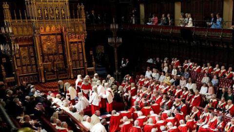 Peers dressed in red ceremonial robes sit in the House of Lords chamber ahead of the State Opening of Parliament in July
