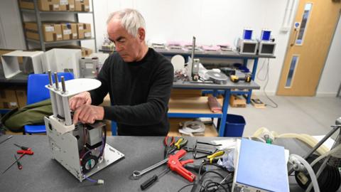 Medical ventilators are constructed at the OES medical supply company in Witney, central Britain, 23 March 2020. OES builds and supplies medical ventilators globally. They are altering their designs to make it more efficient and user friendly to use in treating coronavirus to meet any shortages. Britain"s Prime Minister Boris Johnson has urged UK citizens to avoid unnecessary social contacts, to work from home where possible, and to close schools, pubs and restaurants. Several European countries have closed borders, schools as well as public facilities, and have cancelled most major sports and entertainment events in order to prevent the spread of the SARS-CoV-2 coronavirus causing the Covid-19 disease.