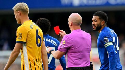 Reece James reacts to referee Simon Hooper showing a red card to Trevoh Chalobah 