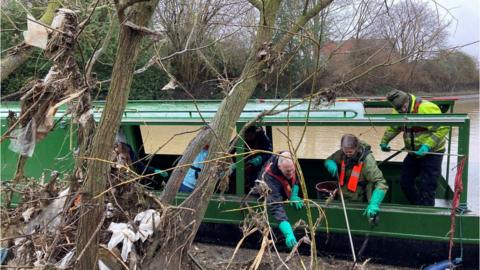 Volunteers using a narrow boat