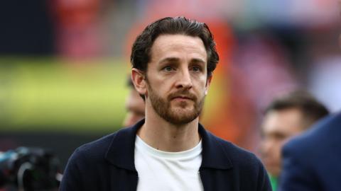 Tom Lockyer while working as a pundit at the Championship play-off final at Wembley in June 2025
